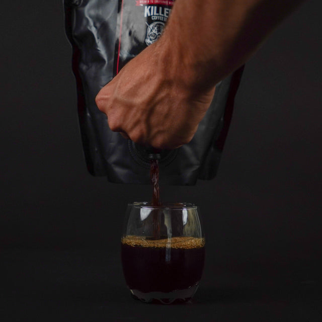 Killer Concentrate pouring from its bag into a glass